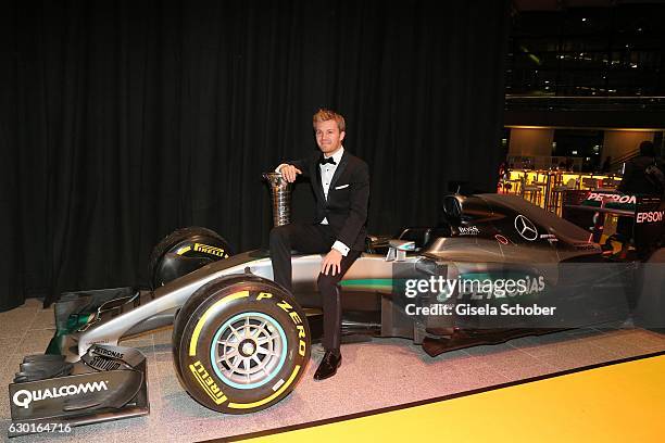 Nico Rosberg, Formula One, F1 driver and World Champion 2016 sits on his car with trophy during the ADAC sportgala 'Die Nacht der Sieger 2016' on...