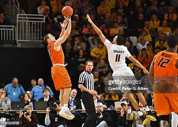 Guard Phil Forte III of the Oklahoma State Cowboys hits a three-point shot against guard Landry Shamet of the Wichita State Shockers during the...