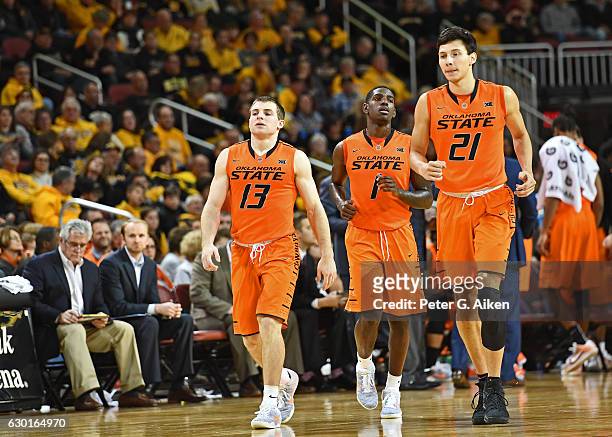 Players Jawun Evans, Phil Forte III and Lindy Waters III of the Oklahoma State Cowboys walk up the court against the Wichita State Shockers during...