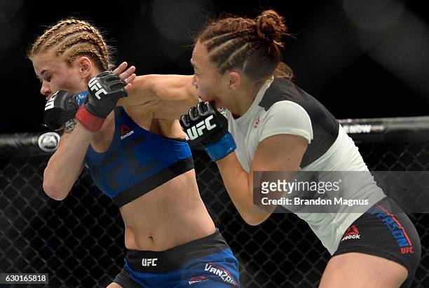 Michelle Waterson punches Paige VanZant in their women's strawweight bout during the UFC Fight Night event inside the Golden 1 Center Arena on...