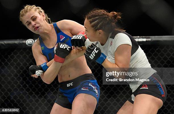 Michelle Waterson punches Paige VanZant in their women's strawweight bout during the UFC Fight Night event inside the Golden 1 Center Arena on...