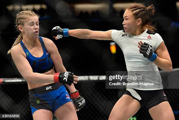 Michelle Waterson punches Paige VanZant in their women's strawweight bout during the UFC Fight Night event inside the Golden 1 Center Arena on...