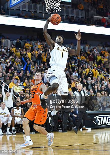 Forward Zach Brown of the Wichita State Shockers drives in for a basket past guard Phil Forte III of the Oklahoma State Cowboys during the second...