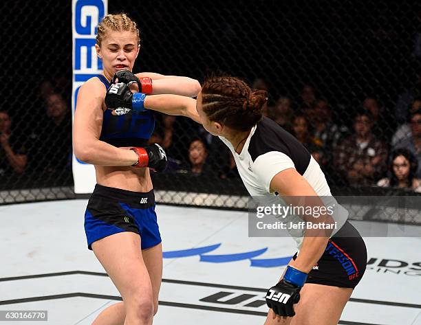 Michelle Waterson punches Paige VanZant in their women's strawweight bout during the UFC Fight Night event inside the Golden 1 Center Arena on...