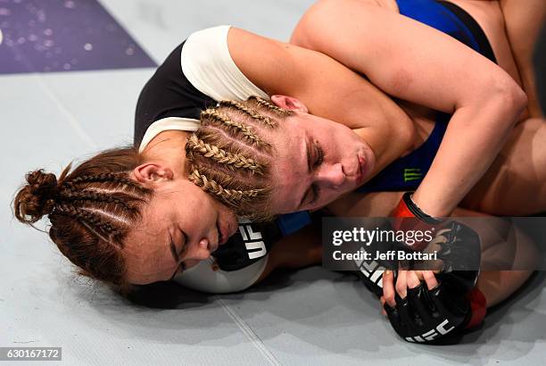 Michelle Waterson secures a rear choke submission against Paige VanZant in their women's strawweight bout during the UFC Fight Night event inside the...