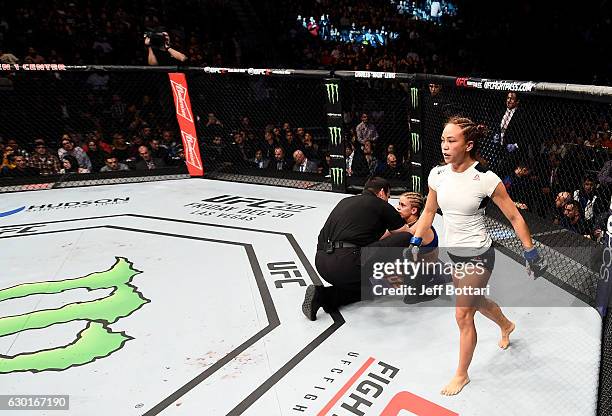 Michelle Waterson celebrates after her submission victory over Paige VanZant in their women's strawweight bout during the UFC Fight Night event...