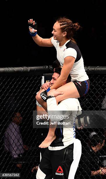 Michelle Waterson celebrates after her submission victory over Paige VanZant in their women's strawweight bout during the UFC Fight Night event...