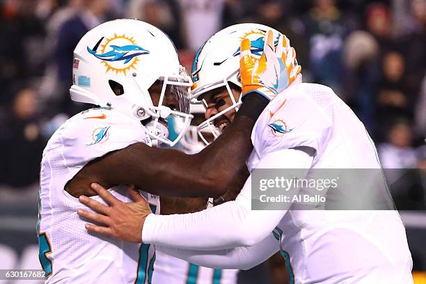 Matt Moore of the Miami Dolphins celebrates with Jarvis Landry after scoring a touchdown against the New York Jets during the third quarter of the...