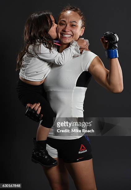 Michelle Waterson and daughter Araya pose for a portrait backstage after her victory over Paige VanZant during the UFC Fight Night event inside the...