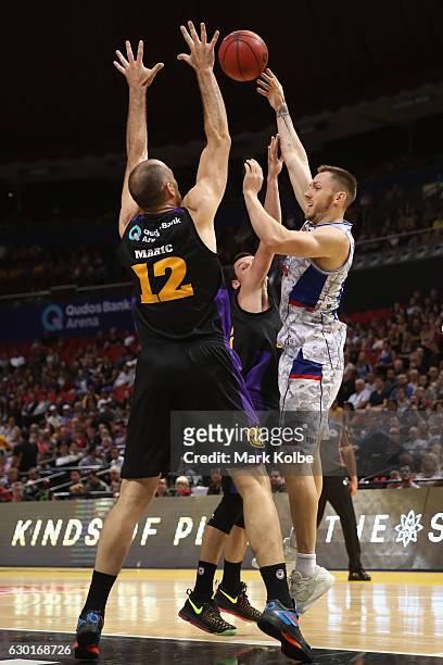 Aleks Maric and Jason Cadee of the Kings put pressure on Mitch Creek of the Adelaide 36ers as he passes during the round 11 NBL match between Sydney...