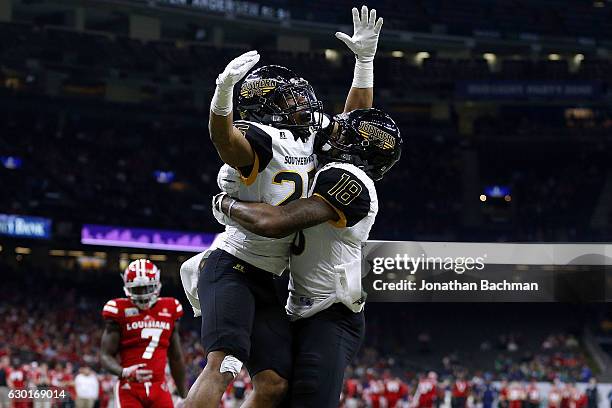 Ito Smith of the Southern Miss Golden Eagles celebrates a touchdown with Korey Robertson during the first half of a game against the...