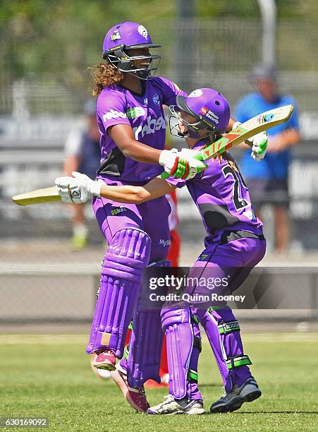 Erin Burns of the Hurricanes is congratulated by Hayley Matthews after hitting the winning runs in the super over during the WBBL match between the...