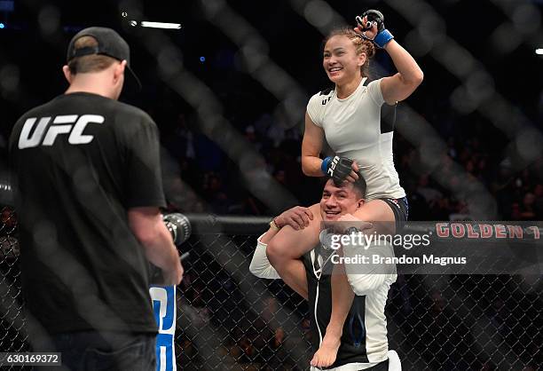 Michelle Waterson celebrates her victory over Paige VanZant in their women's strawweight bout during the UFC Fight Night event inside the Golden 1...