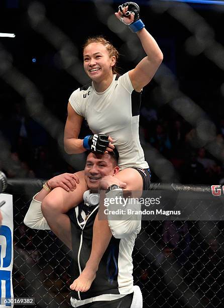 Michelle Waterson celebrates her victory over Paige VanZant in their women's strawweight bout during the UFC Fight Night event inside the Golden 1...