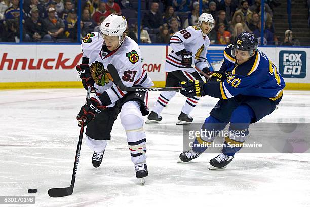 Chicago Blackhawks defenseman Brian Campbell and St. Louis Blues left wing Alexander Steen battles for the puck during a NHL hockey game between the...