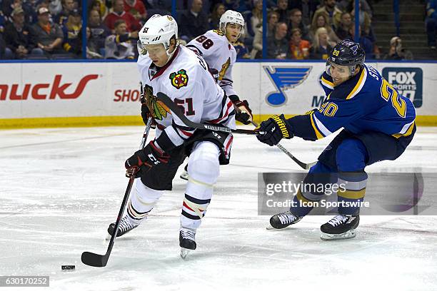 Chicago Blackhawks defenseman Brian Campbell and St. Louis Blues left wing Alexander Steen battles for the puck during a NHL hockey game between the...