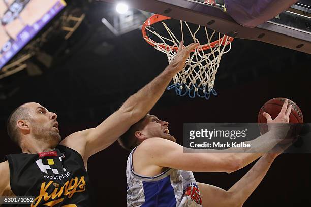 Matt Hodgson of the Adelaide 36ers lays up a shot under pressure from Aleks Maric of the Kings during the round 11 NBL match between Sydney and...