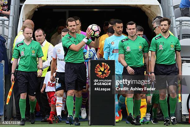 Referees walk out on the ground during the round 11 A-League match between the Central Coast Mariners and Brisbane Roar at Central Coast Stadium on...