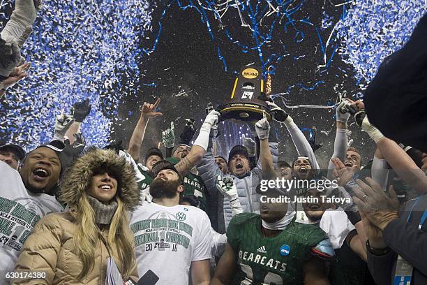 Head Coach Adam Dorrel of Northwest Missouri State University raises the Championship Trophy with his team following the Division II Men's Football...
