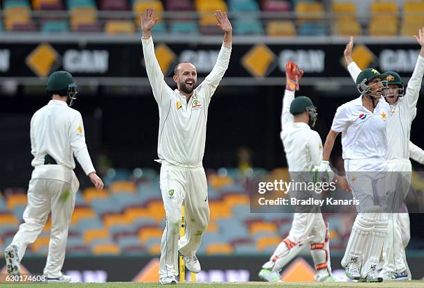 Nathan Lyon of Australia celebrates after taking the wicket of Younis Khan of Pakistan during day four of the First Test match between Australia and...