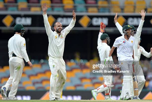 Nathan Lyon of Australia celebrates with team mates after taking the wicket of Younis Khan of Pakistan during day four of the First Test match...