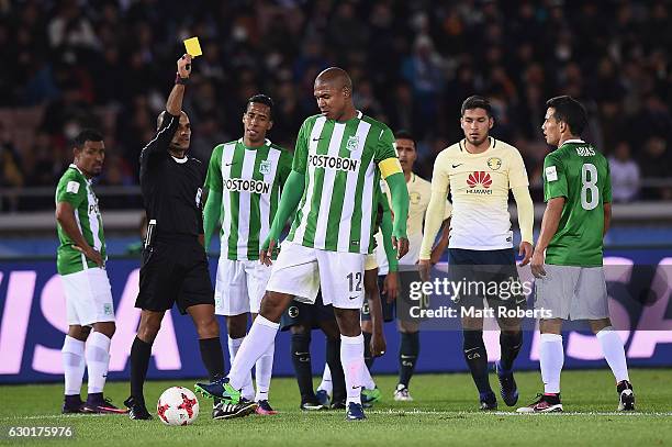 Alexis Henriquez of Atletico Nacional is given a yellow card by referee Nawaf Shukralla during the FIFA Club World Cup 3rd place match between Club...