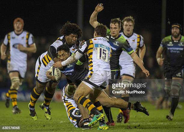 Bundee Aki of Connacht tackled by Josh Bassett, Rob Miller and Thomas Young of Wasps during the European Rugby Champions Cup Round 4 match between...