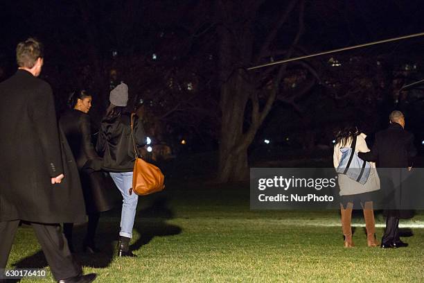 President Barack Obama and his daughter Sasha depart the White House before boarding Marine One on the South Lawn December 16, 2016 in Washington,...