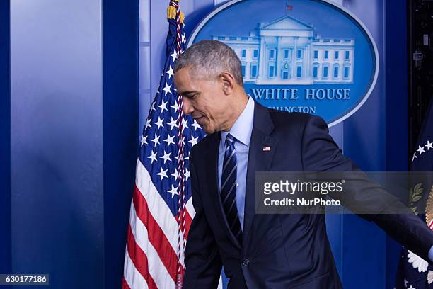 President Barack Obama leaves after a year-end press conference in the Brady Press Briefing Room of the White House in Washington, DC, December 16,...