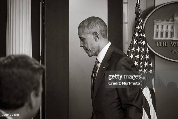 President Barack Obama leaves after a year-end press conference in the Brady Press Briefing Room of the White House in Washington, DC, December 16,...