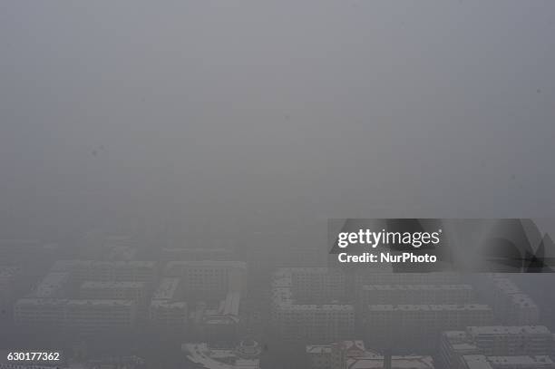 Photo taken from the Dragon tower,a supertall skyscraper under construction at the Nangang district, shows the city being shrouded in heavy smog on...