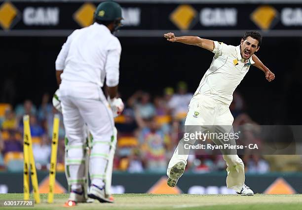 Mitchell Starc of Australia celebrates after taking the wicket of Sarfraz Ahmed of Pakistan during day four of the First Test match between Australia...