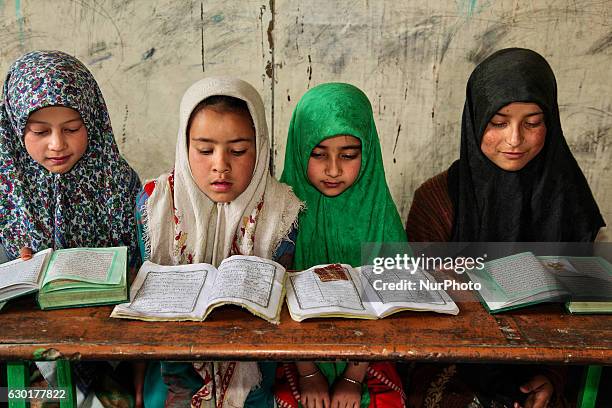 Muslim children study the Quran at a Madrassa in a small village near the town of Kargil in Ladakh, Jammu and Kashmir, India on June 25, 2014. .