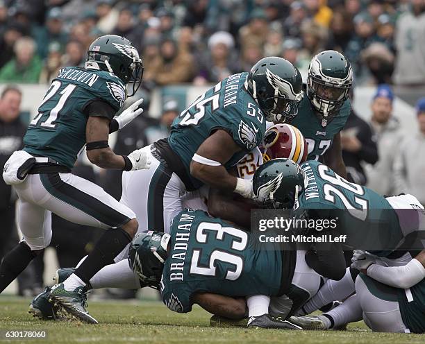 Leodis McKelvin, Brandon Graham, Nigel Bradham, Malcolm Jenkins, and Jaylen Watkins of the Philadelphia Eagles tackle Rob Kelley of the Washington...