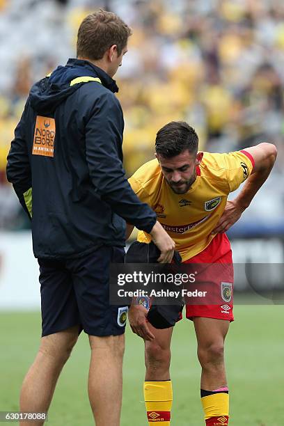 Michael Neill of the Mariners is walked off injured during the round 11 A-League match between the Central Coast Mariners and Brisbane Roar at...