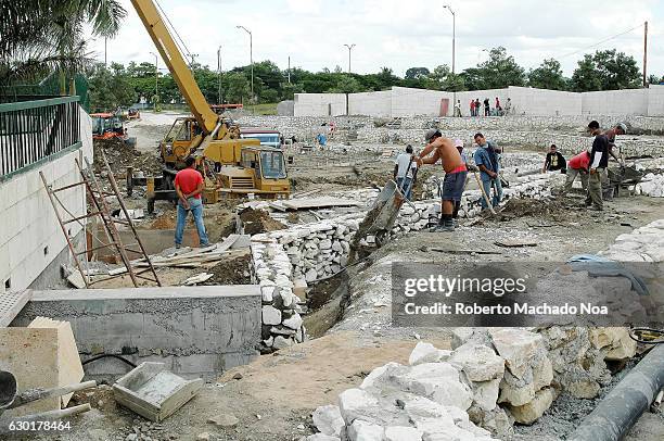 The process of Che Guevara Memorial construction. Builders are laying the foundations and surveyor is determining position and distance.