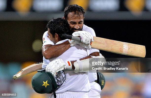 Asad Shafiq of Pakistan celebrates with team mate Wahab Riaz after scoring a century during day four of the First Test match between Australia and...