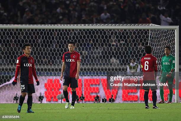 Gen Shoji of Kashima Antlers and his team-mates look dejected after Cristiano Ronaldo of Real Madrid scored his team's third goal to make the score...