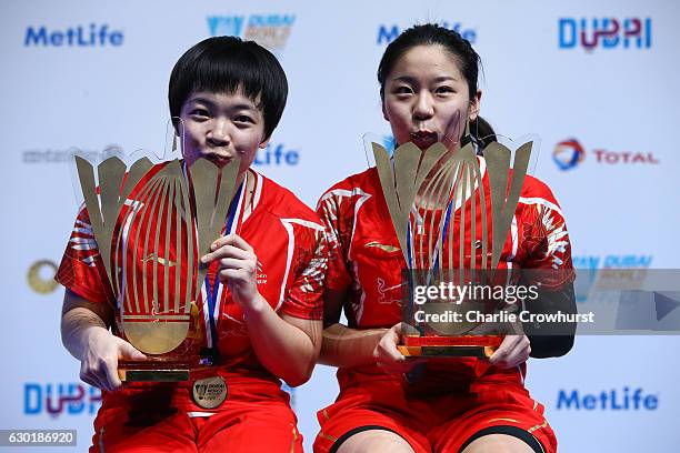 Chen Qingchen and Jia Yifan of China celebrate with their trophies after winning the women's doubles final match against Ayaka Takahashi and Misaki...