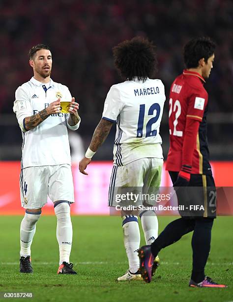 Sergio Ramos of Real Madrid hands Marcelo of Real Madrid the captains arm band during the FIFA Club World Cup Final match between Real Madrid and...