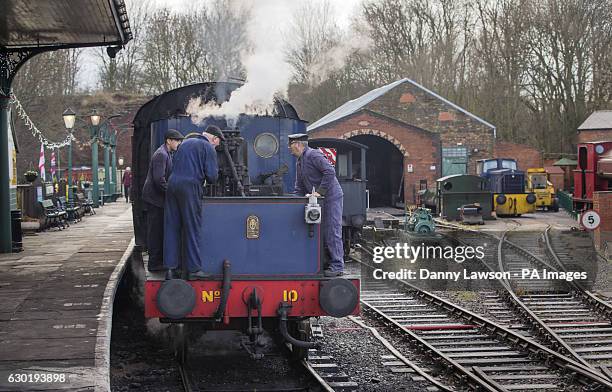 Volunteers with a Sentinel 040 Vertical Boiler Steam train operated by the Elsecar Heritage Railway in Elsecar, Yorkshire.