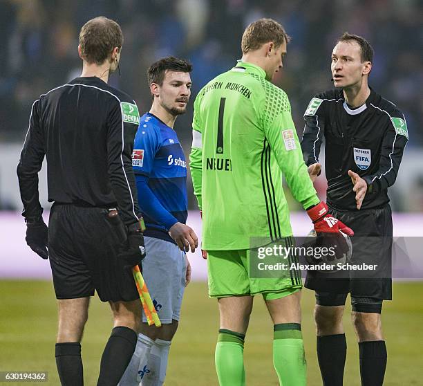 Manuel Neuer of Bayern Muenchen discusses with referee Bastian Dankert and drops the ball during to the Bundesliga match between SV Darmstadt 98 and...