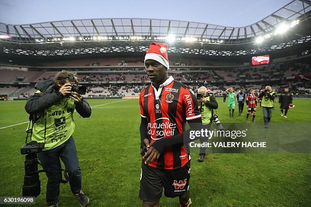 Nice's Italian forward Mario Balotelli, wearing a Santa Claus bonnet, walks on the pitch at the end of the French L1 football match Nice vs Dijon on...