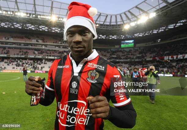 Nice's Italian forward Mario Balotelli, wearing a Santa Claus bonnet, walks on the pitch at the end of the French L1 football match Nice vs Dijon on...