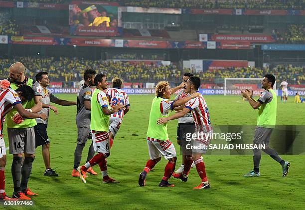 Atletico de Kolkata players celebrate after winning the Indian Super League final football match against Kerala Blasters FC at the Jawahar Lal Nehru...