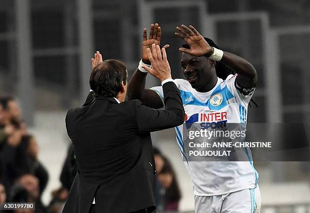 Olympique de Marseille's French forward Bafetimbi Gomis celebrates with Olympique de Marseille's French head coach Rudi Garcia after scoring during...