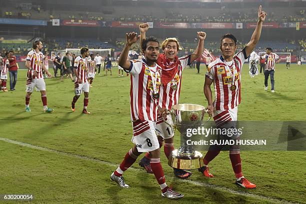 Atletico de Kolkata's Jewel Raja Shaikh , Atletico de Kolkata's midfielder Bidyananda Singh , Lalrindika Ralte celebrate with the trophy after...