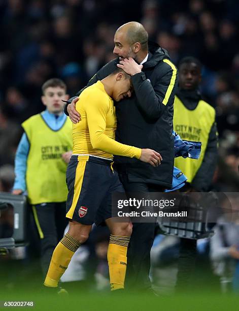 Alexis Sanchez of Arsenal and Josep Guardiola, Manager of Manchester City embrace after the final whistle during the Premier League match between...