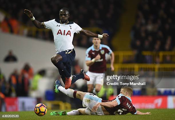 Moussa Sissoko of Tottenham Hotspur jumps over Ben Mee of Burnley challenge during the Premier League match between Tottenham Hotspur and Burnley at...