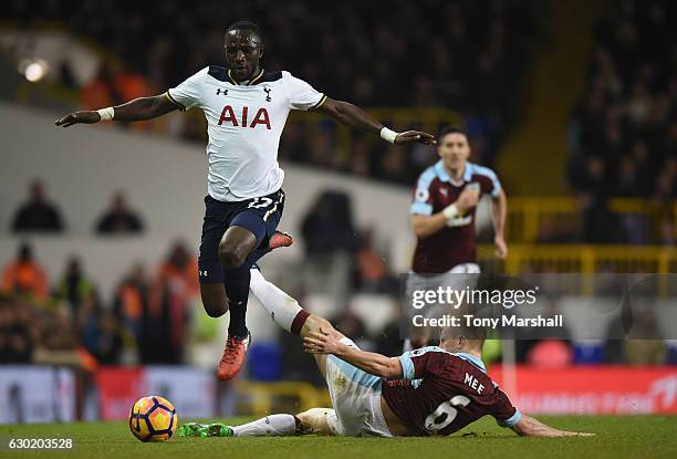 Moussa Sissoko of Tottenham Hotspur jumps over Ben Mee of Burnley challenge during the Premier League match between Tottenham Hotspur and Burnley at...